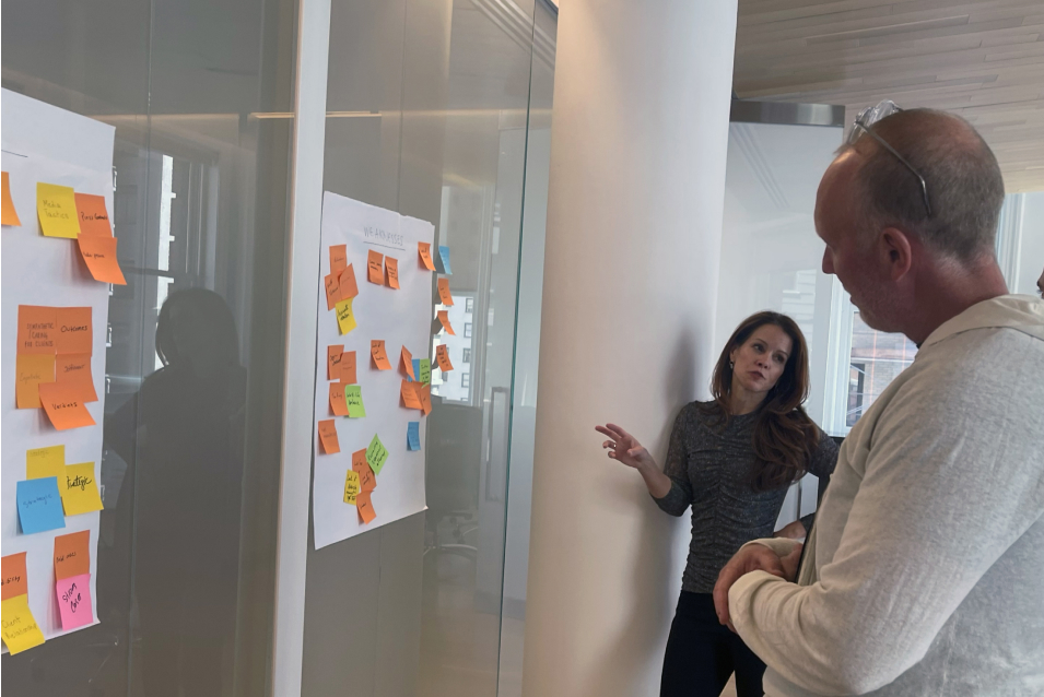 KDS Founder, Brandie Knox, talking in front of sticky notes whiteboard.